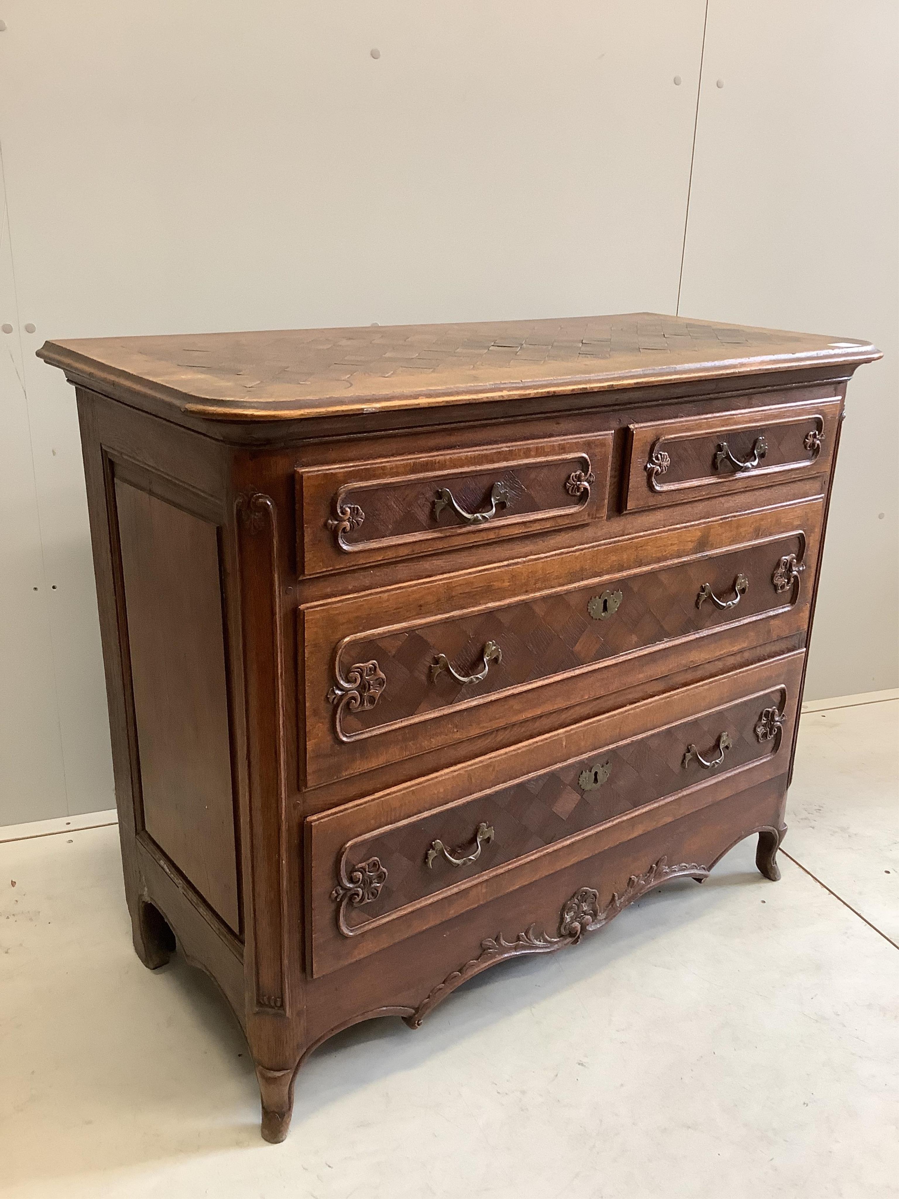 An early 18th century French oak and parquetry commode, width 110cm, depth 52cm, height 92cm